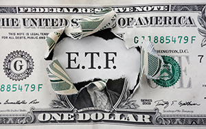 Torn dollar with ETF message, Exchange Traded Fund stock market concept